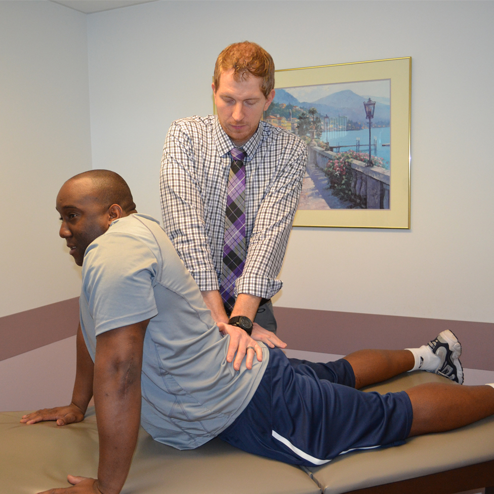 physical therapist helping patient